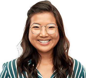 woman wearing glasses and striped shirt smiling