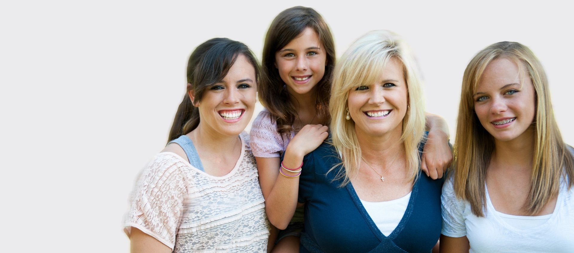 mother and daughters smiling