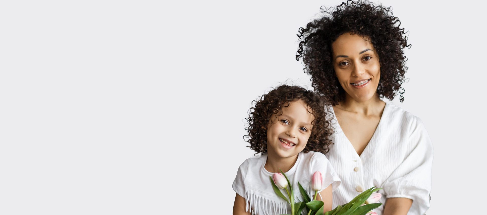 mother and daughter smiling with flowers